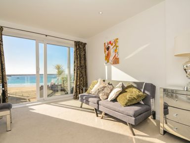 A living room with a sofa and sea view at The View in Newquay