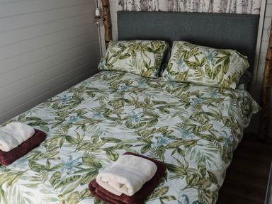 A bedroom with a bed and pillows at Reflection in Longtown