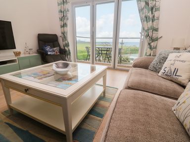 A living room with a coffee table and sofa at Ocean Seven in Newquay
