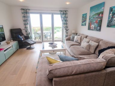 A living room with a sofa and coffee table at Ocean Seven in Newquay