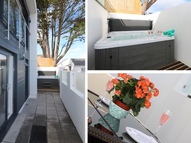 An outdoor patio with a hot tub a potted plant on a table and two glasses with pink liquid at An Drowes in Newquay