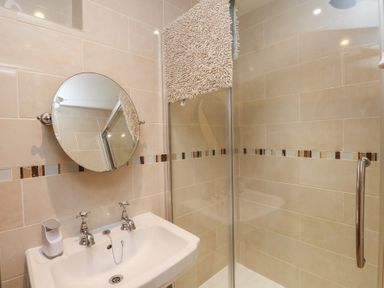 A bathroom with a sink and shower at Plas Mawr in Groeslon