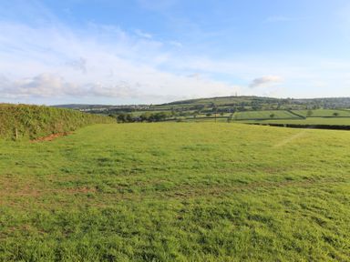 A landscape view with grass and hills at Cedar Lodge in Lanivet near Bodmin