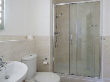 A bathroom with a sink toilet and shower cubicle at Tyack in Charlestown