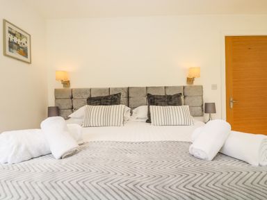 A bedroom with a double bed with pillows towels and lamps at Elm in Truro