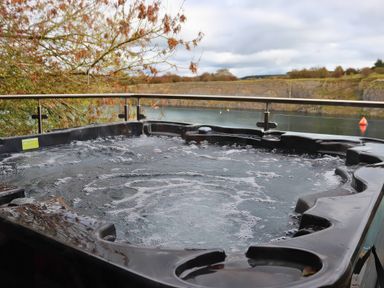 A hot tub overlooking water at Boavista in Carnforth