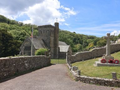 A church with a memorial and flag in Branscombe at Pottery Barn