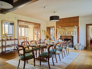 A dining room with a table and chairs at Great Bidlake Manor in Bridestowe, near Lydford