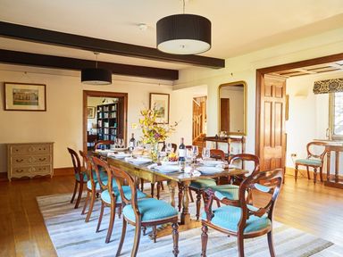A dining room with a table set for dinner at Great Bidlake Manor in Bridestowe near Lydford