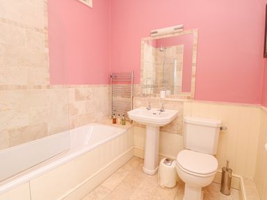 A bathroom with a bathtub shower sink toilet and mirror at Wootton House in Butleigh Wootton near Compton Dundon