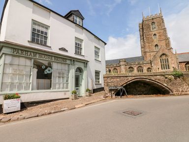 A street view with a bridal shop and a historic church on Church Street at Castle View in Dunster
