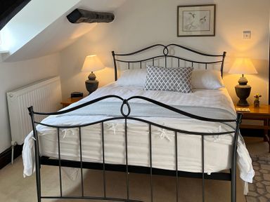 A bedroom with a bed and bedside lamps at Castle View in Dunster