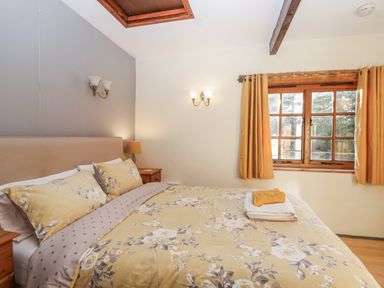 A bedroom with a bed and window at Miners Dry in Gulworthy, near Tavistock