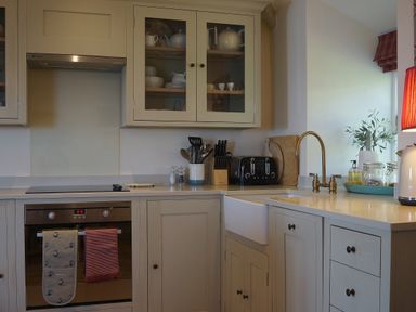 A kitchen with various appliances and utensils at Coach House Cottage, Strete, near Dartmouth