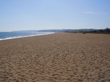 A beach with sand and ocean at Coach House Cottage, Strete, near Dartmouth