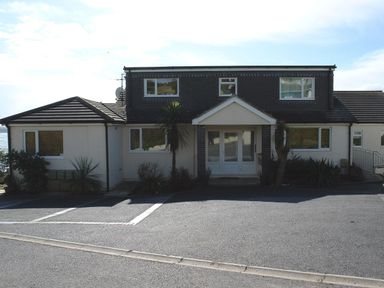 A two-story house with a central entrance and windows on both floors at 3 Tarifa in Bigbury-on-Sea