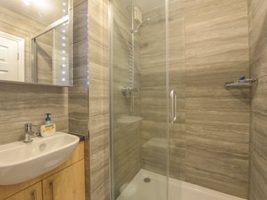 A bathroom with a sink and a glass-enclosed shower at 3 Tarifa in Bigbury-on-Sea