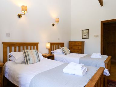 A bedroom with two beds and a dresser at Oak Tree in Halwell