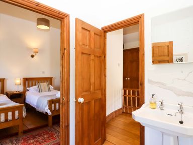 A bedroom with two beds and a sink at Oak Tree in Halwell