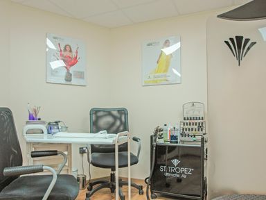 A nail salon room with chairs a table nail equipment and st tropez display at Fixit Cottage Kingsbridge