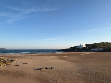 A beach view with sea and buildings at 5 Burgh Island Causeway Bigbury-on-Sea