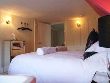 A bedroom with a bed with white linens and rolled towels on top at Maristow Barton Milton Combe near Lopwell Dam
