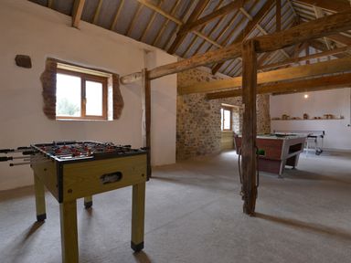 A game room with a foosball table a pool table and a table tennis table at Yellowland Farm in Holsworthy