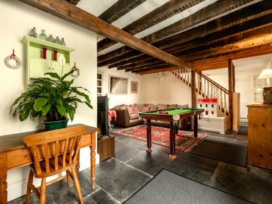 A snug with a pool table and sofa at Parnacott in Holsworthy