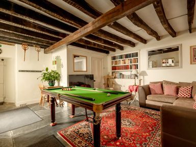 A recreation room with a billiard table and sofa at Parnacott in Holsworthy