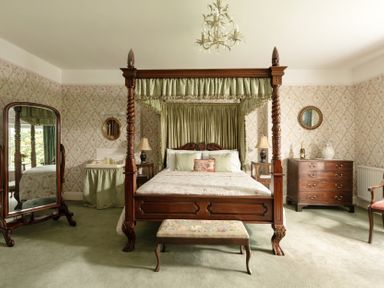 A bedroom with a four-poster bed and furniture at Parnacott in Holsworthy