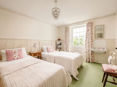 A bedroom with two beds and a washbasin at Parnacott in Holsworthy