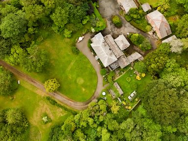 An aerial view of a property surrounded by trees and a pathway at Parnacott in Holsworthy