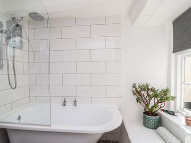 A bathroom with a bathtub and shower at Cousham Cottage in Kingsand And Cawsand
