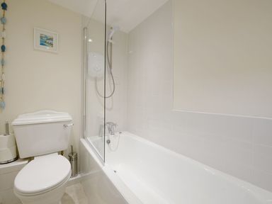 A bathroom with a toilet and a bathtub with a shower at Nirvana in Kingsand And Cawsand