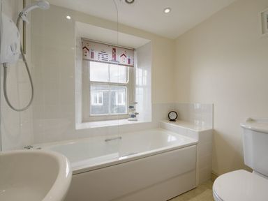 A bathroom with a bathtub shower window toilet and sink at Nirvana in Kingsand And Cawsand
