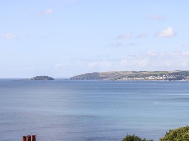 A coastal view with an island and headland across the water at Rock Rose in Downderry