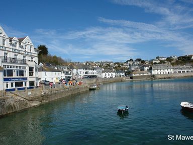 A harbor with boats in the water and buildings along the waterfront at St Mawes