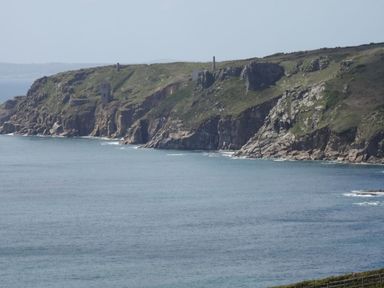 A coastal cliff with stone ruins overlooking the sea at The Studio in Rinsey Cove near Praa Sands