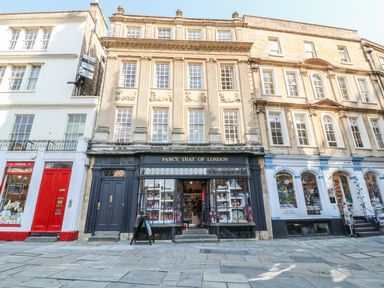A street view of three attached shops with Fancy That Of London in the center at 33 Crescent Gardens in Bath