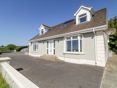 A detached house with a tiled roof and driveway in a rural setting at Tullyally in Redcastle