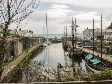 A harbor with several sailboats and buildings along the water at Oh Buoy in Charlestown