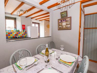 A dining room with a table and chairs at Old Farmhouse Cottage