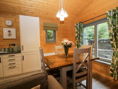 A dining room with a table and chairs at Oak Lodge Pennington near Ulverston