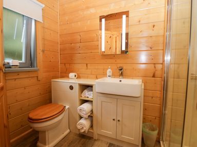 A bathroom with a sink and a shower at Oak Lodge Pennington near Ulverston