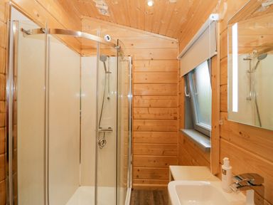 A bathroom with a shower and sink at Oak Lodge Pennington near Ulverston
