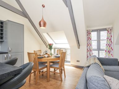 A dining room with a table and chairs at Beach Retreat in Looe