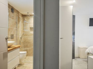A bathroom with a shower and sink at Beach Retreat in Looe