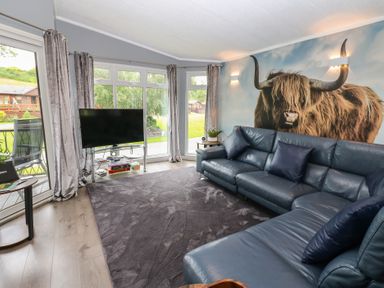A living room with a sofa and television at 16 Badgers Retreat in Richmond