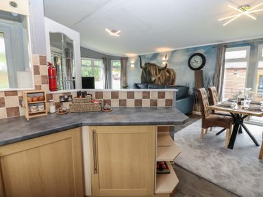 A kitchen with a dining area and wall art at 16 Badgers Retreat in Richmond