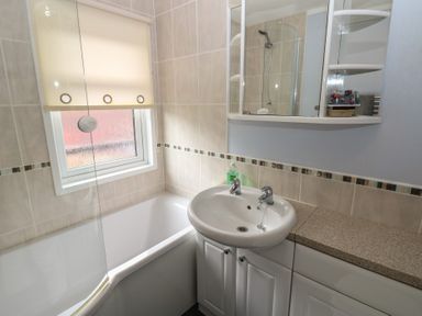 A bathroom with a bathtub and sink at 16 Badgers Retreat in Richmond